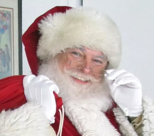 A Santa Claus in a Santa Costume With Glasses